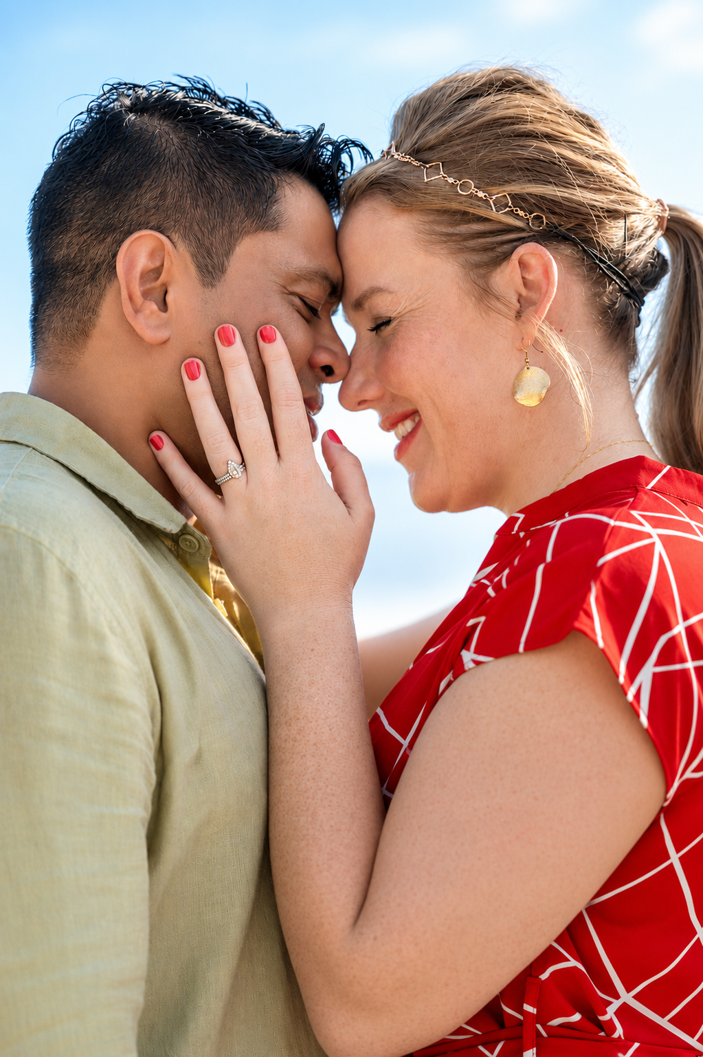 Nadine and Sobah, foreheads touching, engagement ring in view