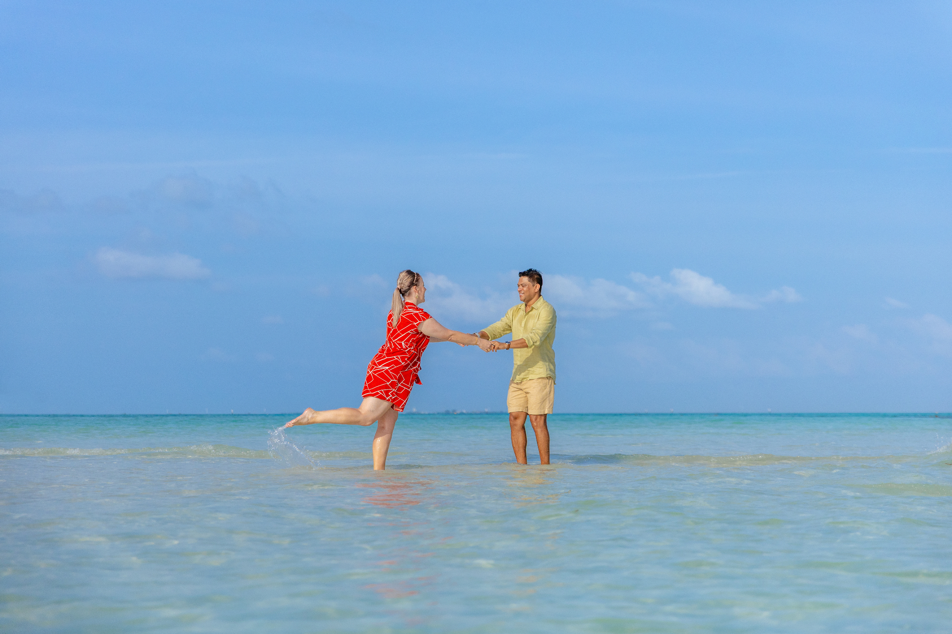 Nadine and Sobah splashing through turquoise Maldivian shallows