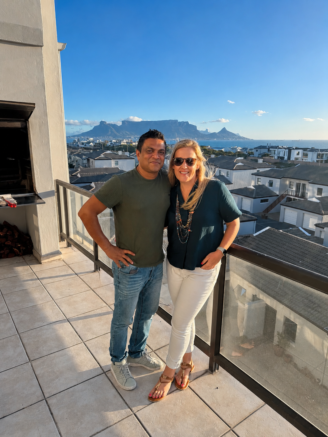 Nadine and Sobah on a Blouberg balcony with Table Mountain behind them